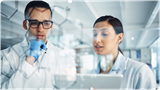 Chemists in lab reviewing properties of chemicals