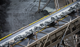 A mining conveyor belt transporting ore rocks, related to the industrial use of peroxide.
