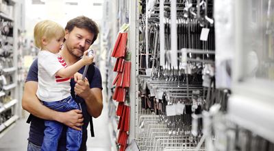 father and young son choosing tools in well assorted store