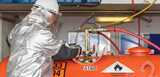 Man in protective clothing working on metal alkyls tank