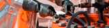 Wearing black gloves unloading metal alkyls cylinder. 