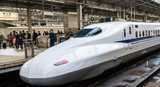 Modern white train leaving Japanese train station