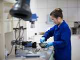 Woman working on lab in blue overall