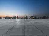 Night view of empty brick floor front of modern building