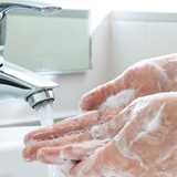 Image of hands washing with soap under water