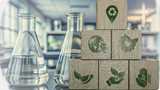Carbon ecological footprint symbols on wooden cubes over chemistry lab.