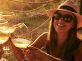 Woman enjoying white wine with friends. Expancel Microspheres is an excellent additive in micro-agglomerated and synthetic wine corks. 