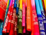 indian fabrics tained in many different colors, decorated with golden and silver embroideries