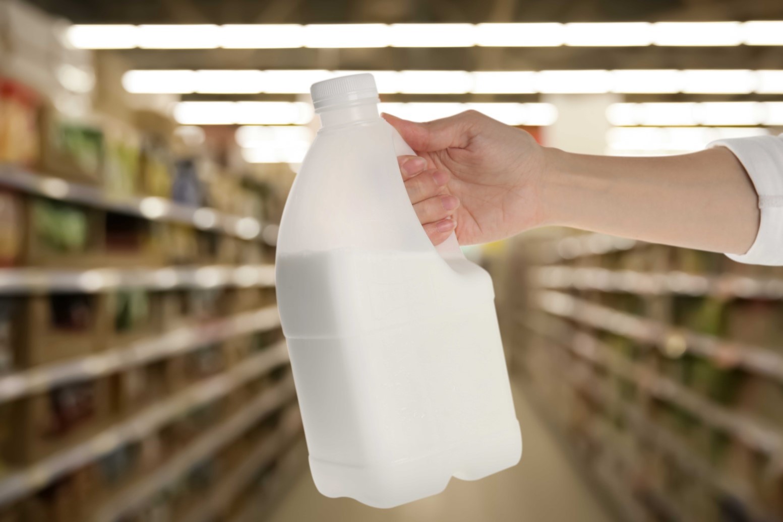Holding a 2-liter plastic milk jar