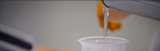 Pouring clear liquid resin in cup