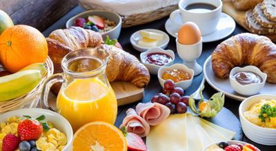 Big breakfast with croissants and orange juice