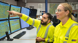 Operators in front of computer screens