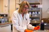 Scientist working in a lab with physical testing equipment—illustrating Nouryon’s innovation environment.
