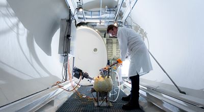 Nouryon employee in lab coat doing an experiment