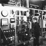 Black and white picture of a worker who stands by industrial control panels and gauges at MoDo's ethylene production facility in Stenungsund.