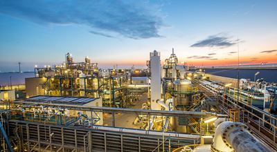 View from above of the Nouryon location in Rotterdam with metal structures and pipes at sunset.